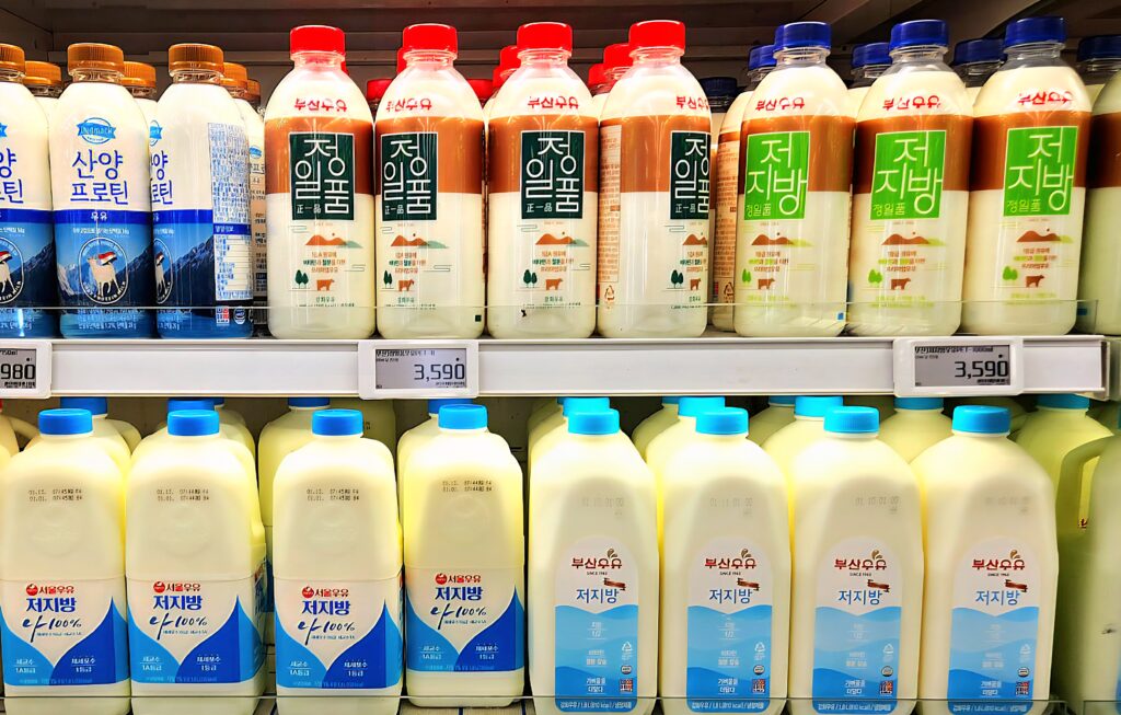 various milk bottles on store shelf showing dairy products rich in calcium and protein