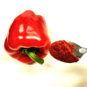sweet red pepper and spoon showing what is paprika powder