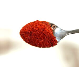 spoonful of paprika powder made from ground red peppers