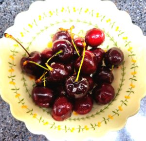 cherries on plate as a healthy late-night snack while dieting